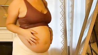 Pregnant changing her clothes